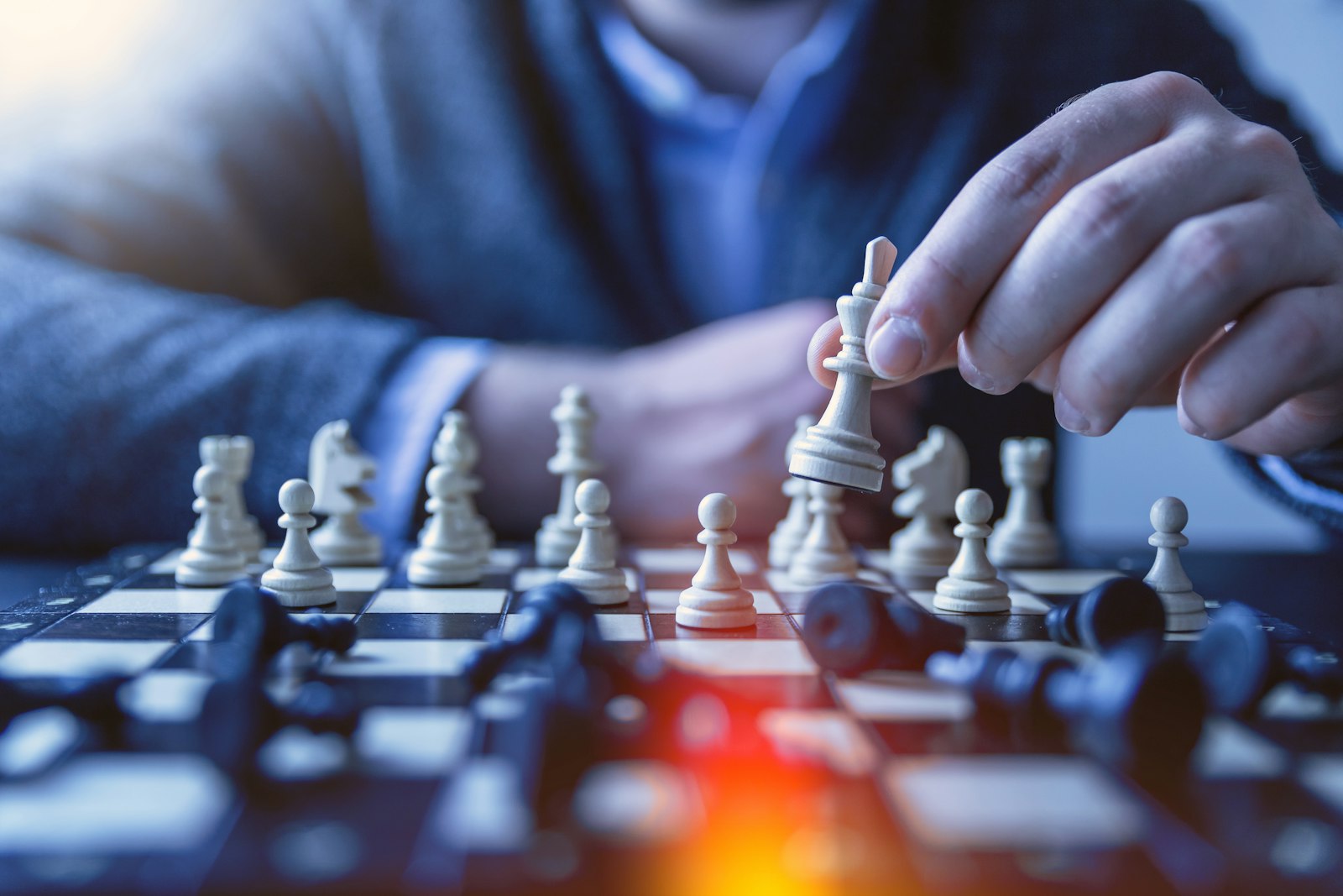Man contemplating his next move over a chess board