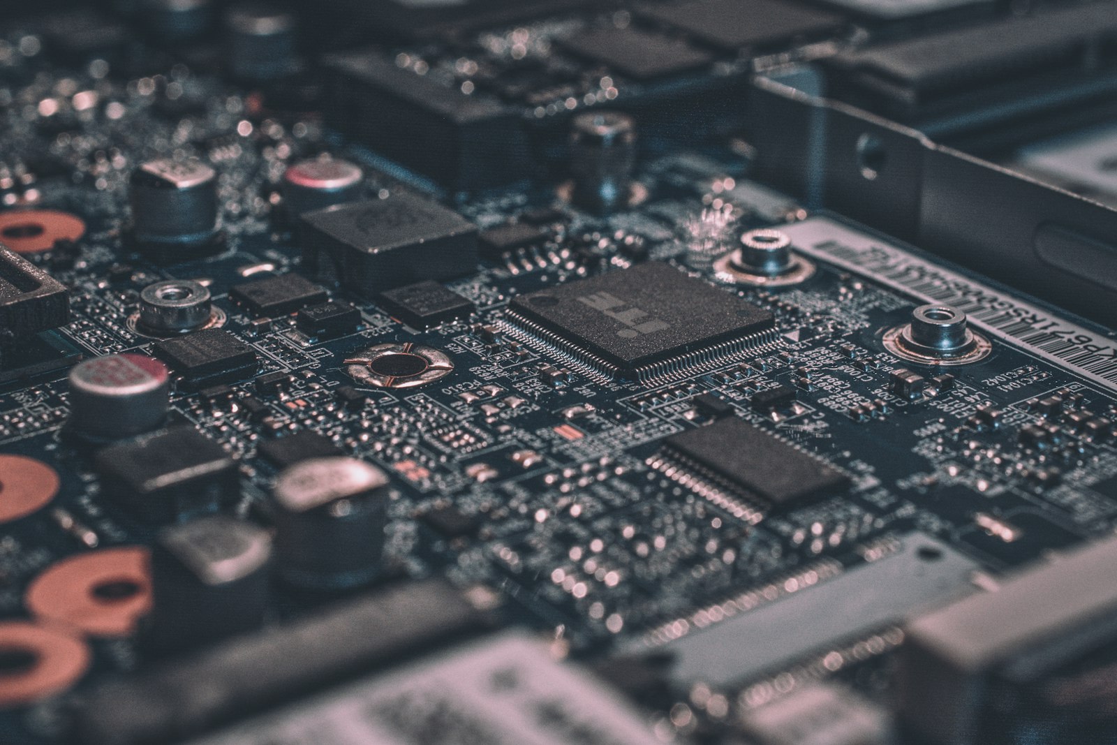 Macro closeup of a black circuit board with soldered components